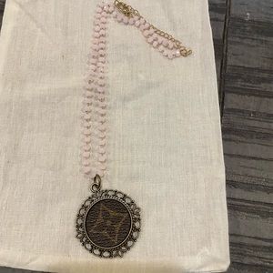 Adorable LV upcycled necklace.